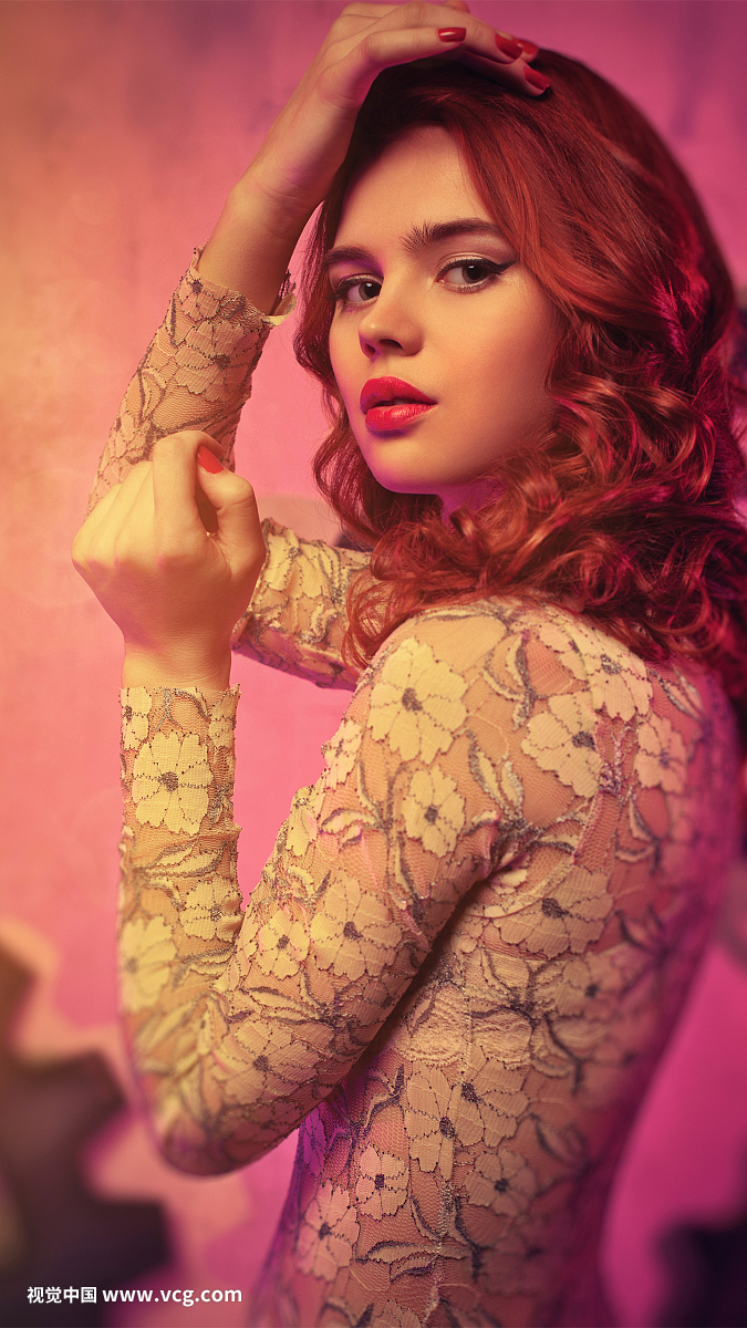 Young woman with red hair portrait. Soft pink tint.