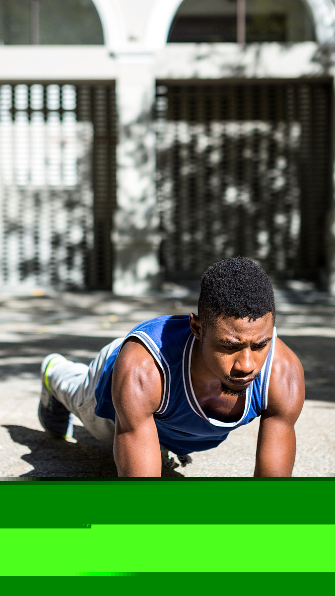 A muscular man on plank position on a sunny day