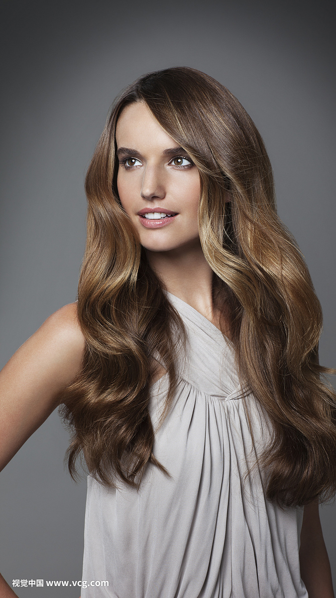 Studio portrait of young woman with long brown hair